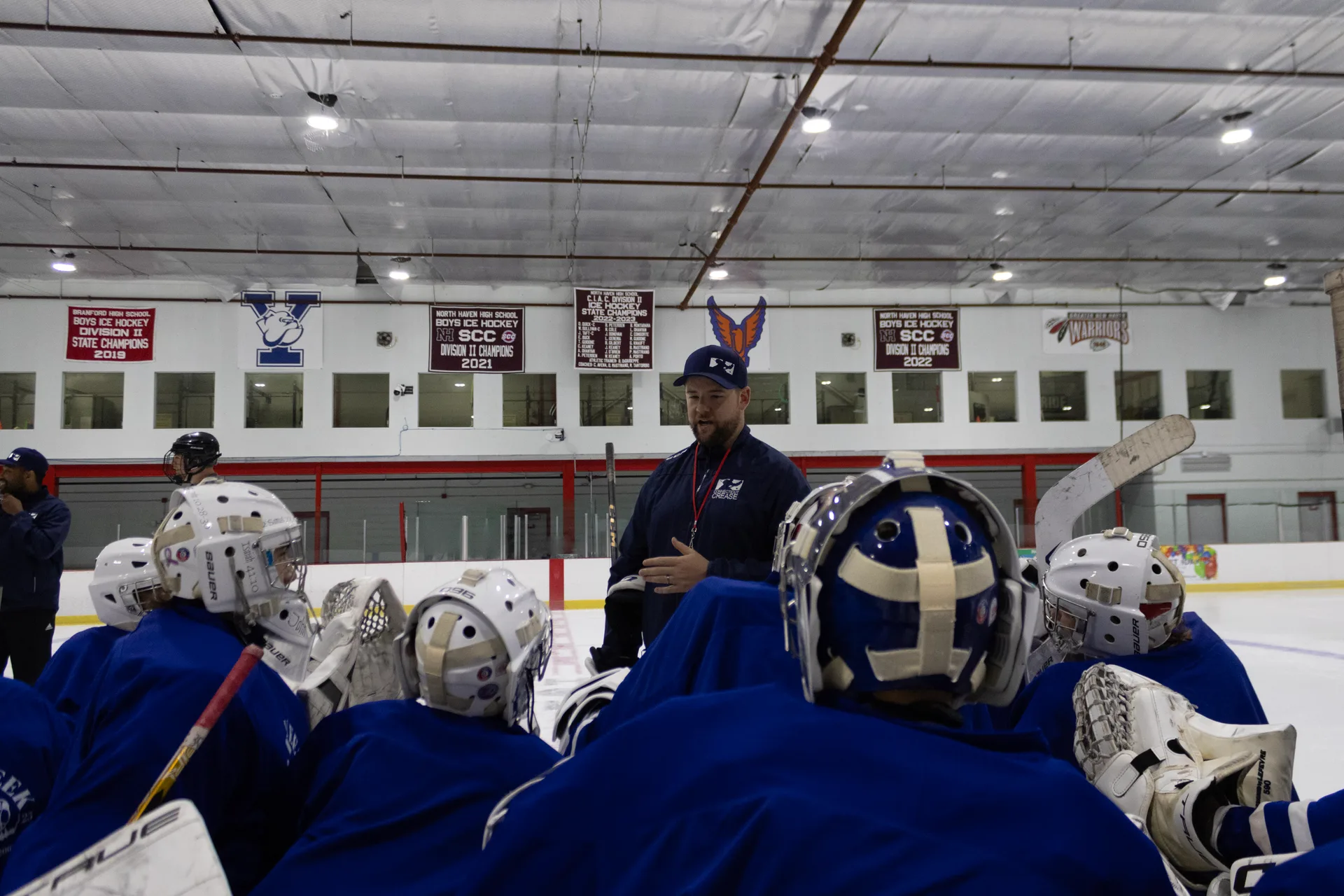Team huddle on ice before a camp session