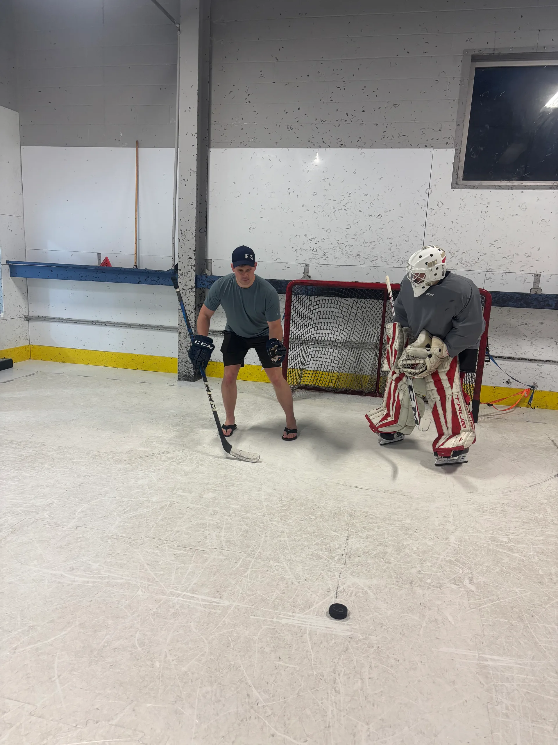 Coach working with a goalie during a Connecticut Crease training session